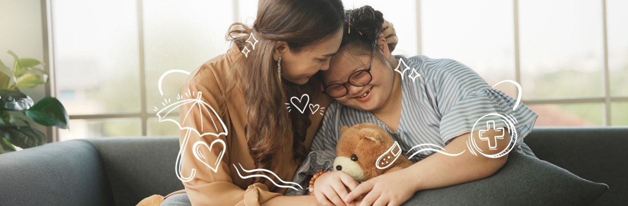 mother and daughter embracing on couch